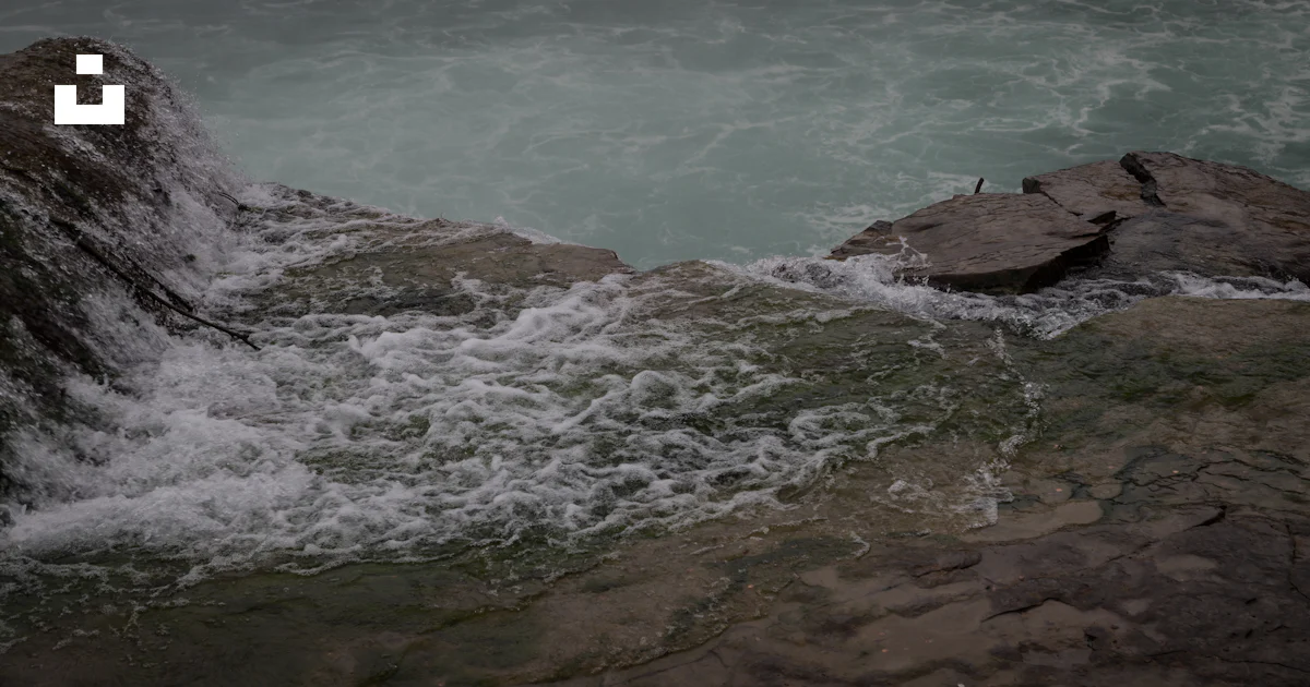 The water is rushing over the rocks in the ocean photo – Free Travel ...