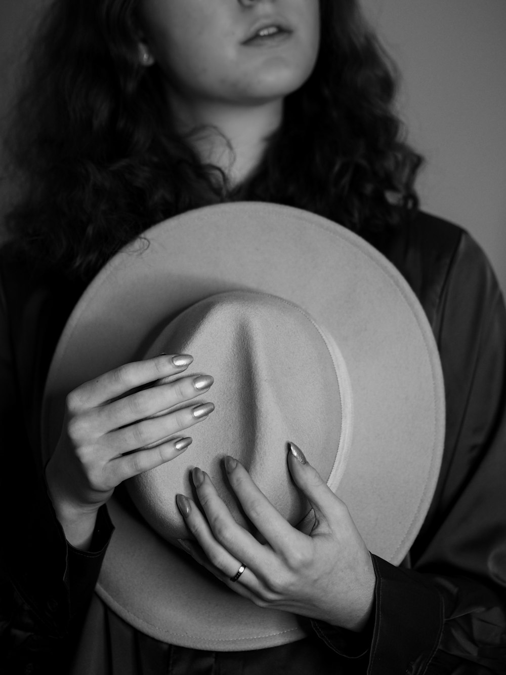 a woman holding a hat in her hands