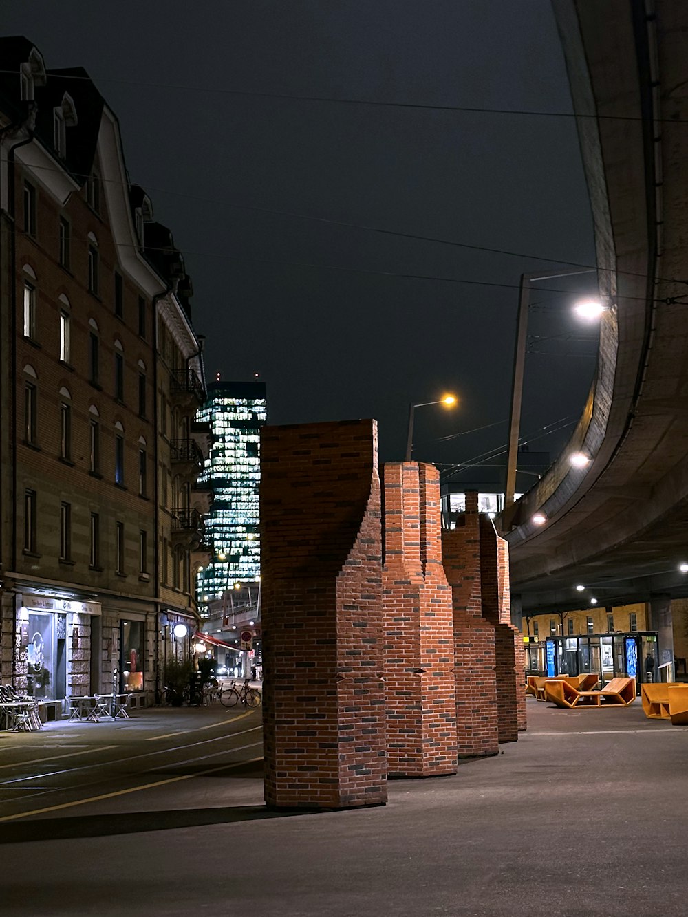 a city street at night with tall buildings