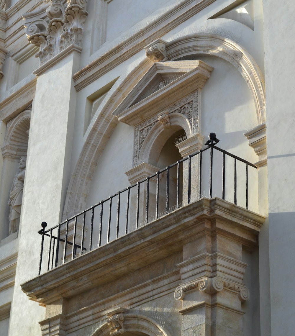 a building with a balcony and a clock on it