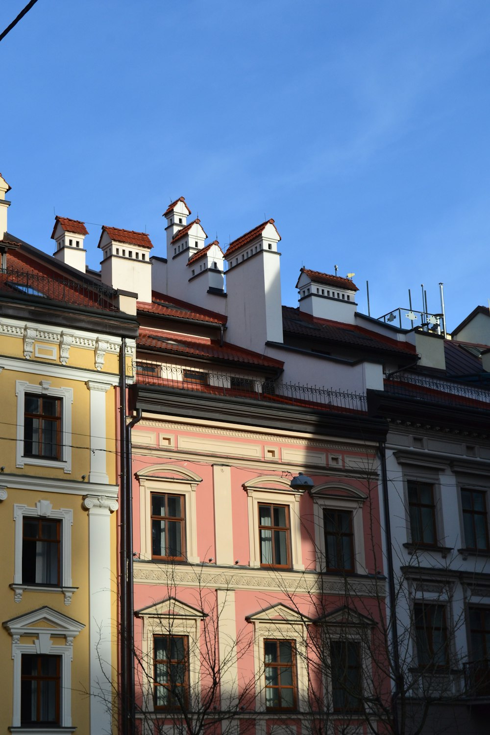 a row of multicolored buildings with a blue sky in the background