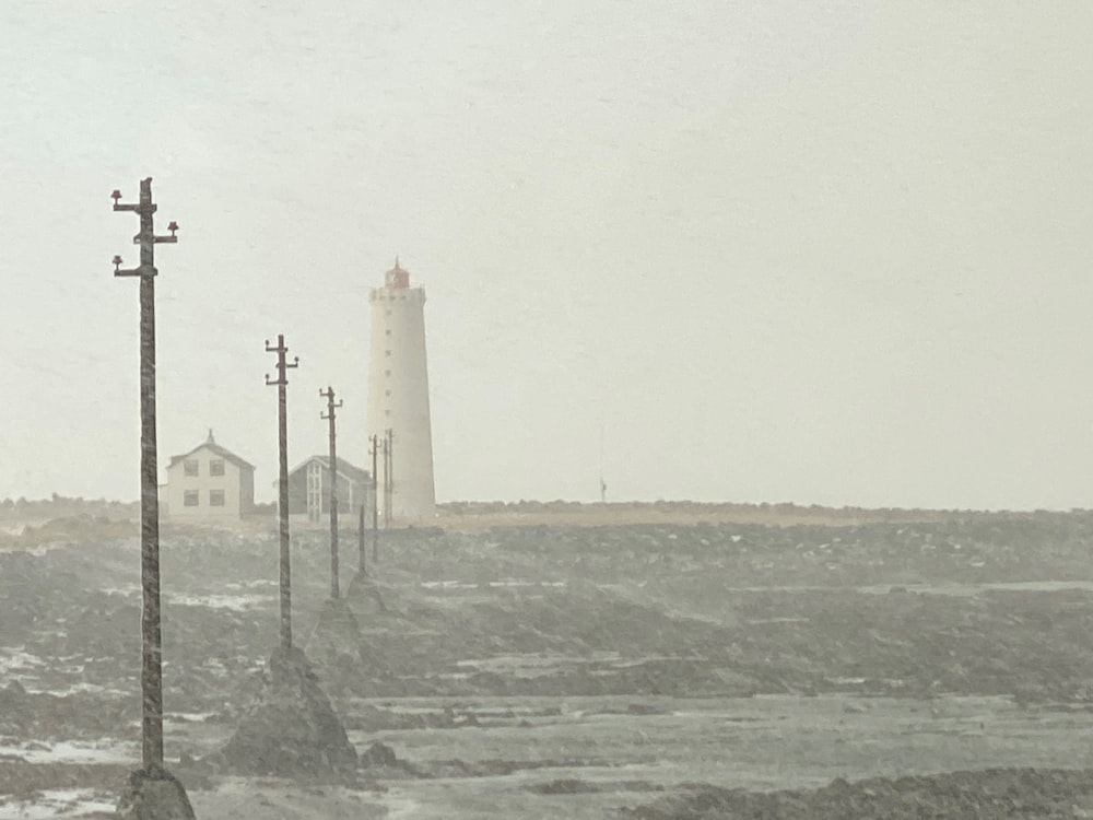 a lighthouse in the distance on a snowy day