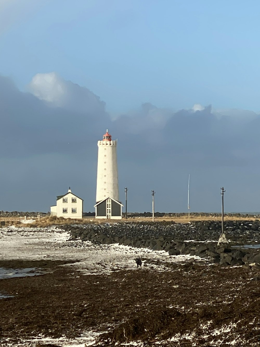 a light house sitting on top of a rocky beach