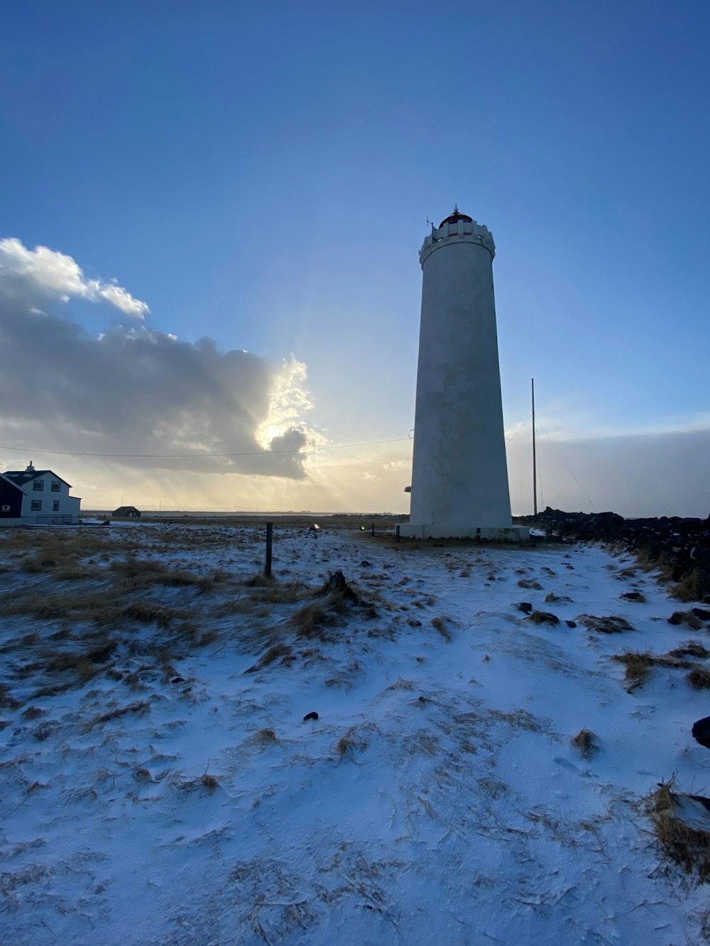 a light house sitting on top of a snow covered field