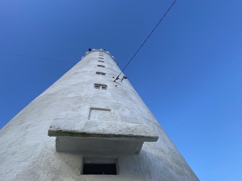 a tall white building with a sky background