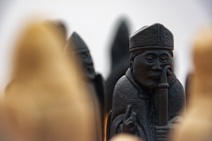 Close-up of a vibrant, hand-crafted polymer clay chess piece with intricate details and bright colors.