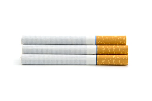 Three cigarettes aligned horizontally, each with a white paper body and a brown filter tip, displayed against a plain white background.