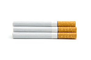 Three cigarettes aligned horizontally, each with a white paper body and a brown filter tip, displayed against a plain white background.