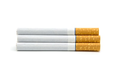 Three cigarettes aligned horizontally, each with a white paper body and a brown filter tip, displayed against a plain white background.
