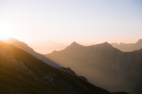 A serene sunrise over a mountain, symbolizing new beginnings and growth.