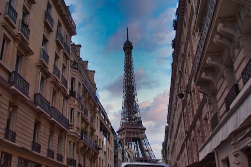 Elegant Parisian street view with the Eiffel Tower in the background at dusk.
