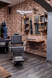 a barber shop with a brick wall and wooden floors