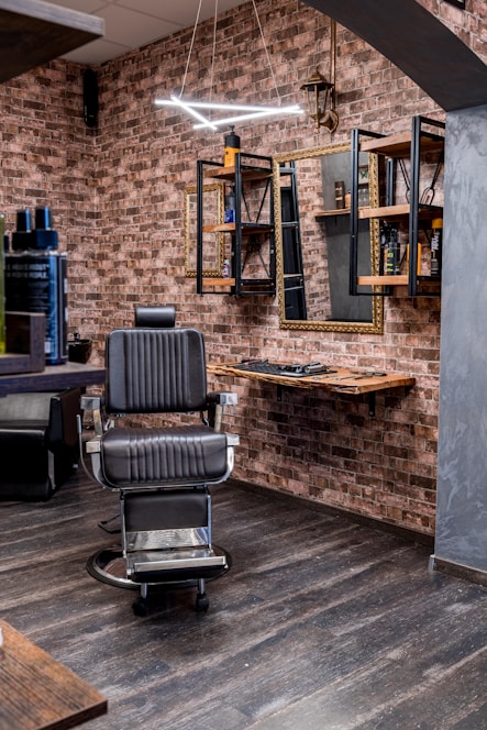 a barber shop with a brick wall and wooden floors