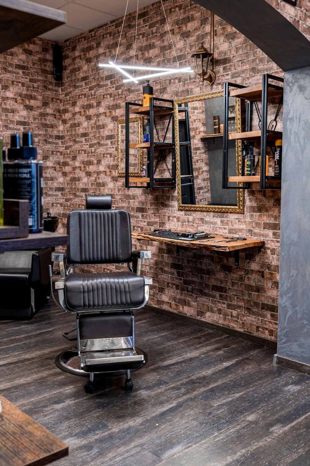 a barber shop with a brick wall and wooden floors