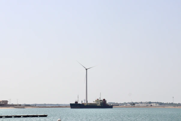 An instructor guiding engineers through a detailed offshore wind turbine model.
