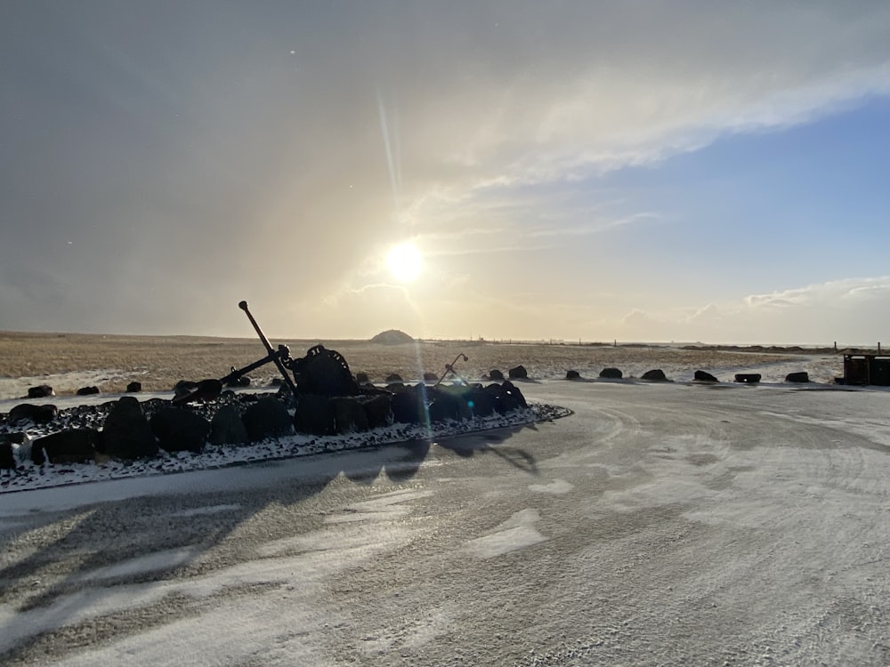 a snow plow sitting on top of a snow covered road