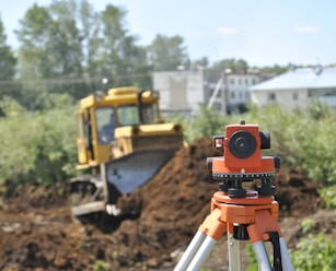 a construction site with a camera on a tripod