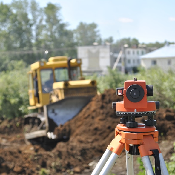 a construction site with a camera on a tripod