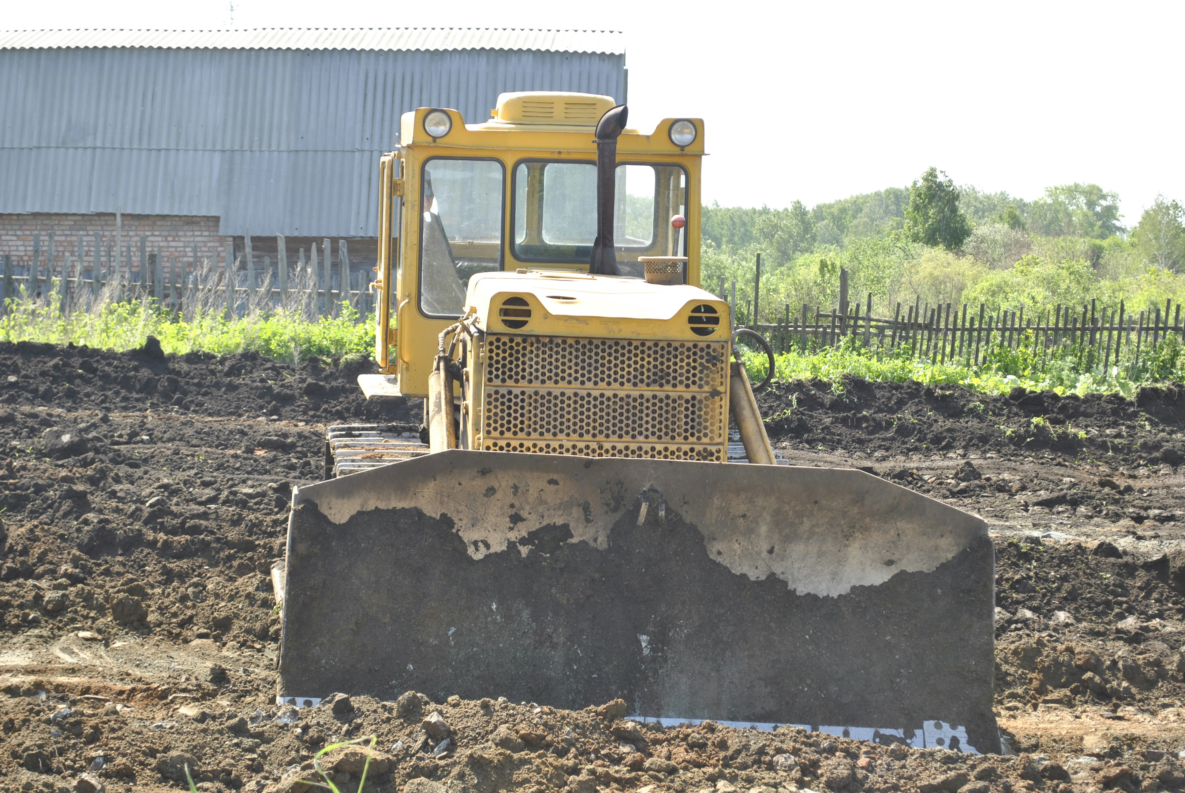 a bulldozer is sitting in the middle of a field