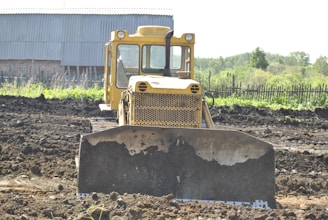 a bulldozer is sitting in the middle of a field