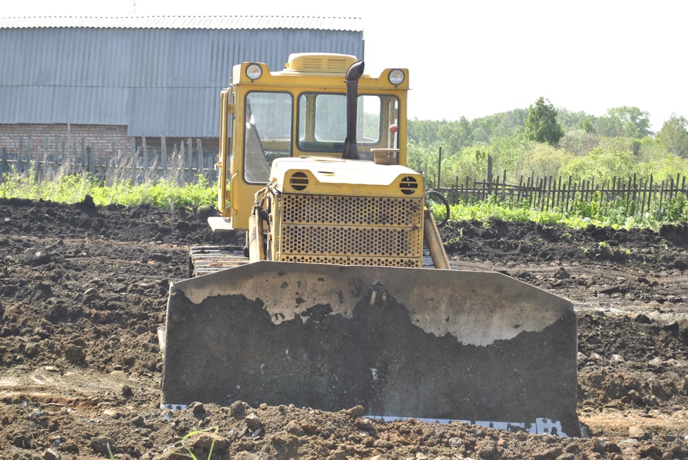 a bulldozer is sitting in the middle of a field