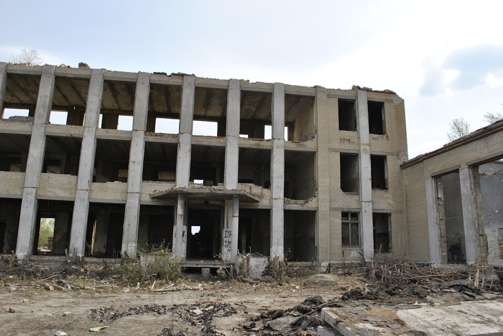 a large building that is being demolished with a sky background