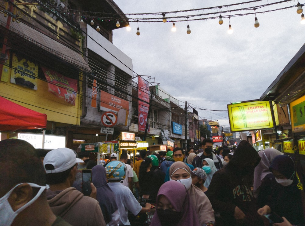 a crowd of people walking down a street