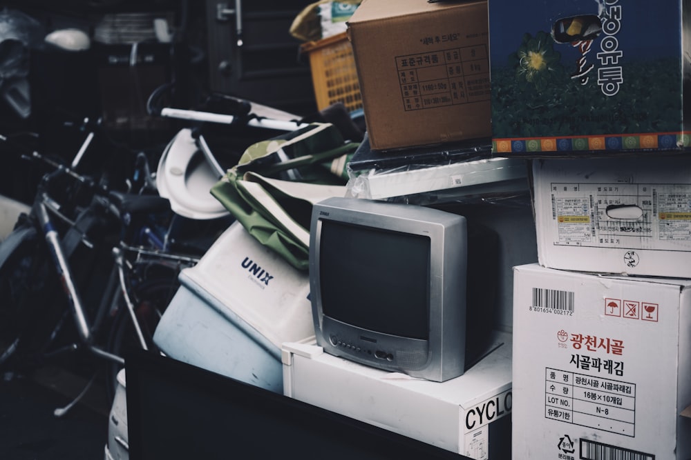 a pile of old televisions and books on a table