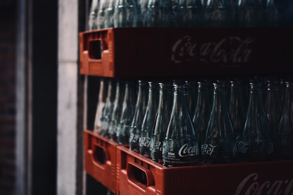 a bunch of coca cola bottles stacked on top of each other