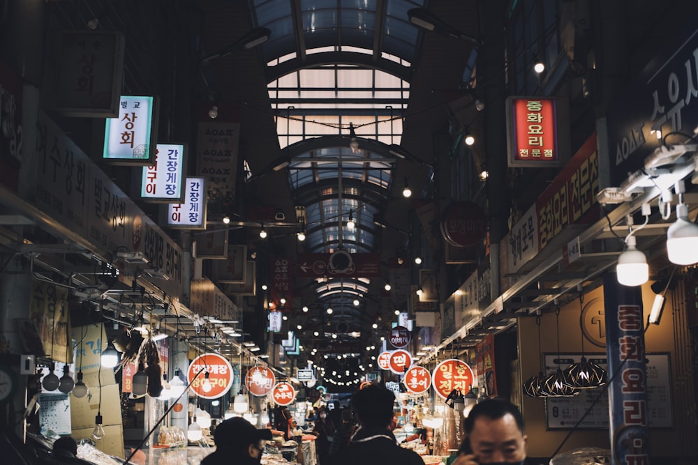 a market with people walking through it at night