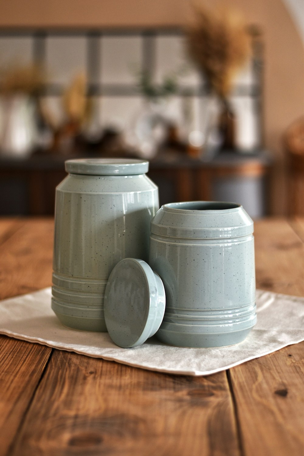 a couple of jars sitting on top of a wooden table