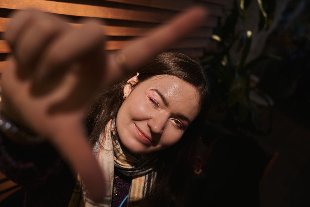 a woman making a face with her fingers