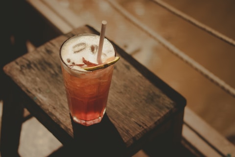 a drink sitting on top of a wooden table