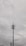 A tall communication tower with multiple antennas and cables is set against a cloudy sky. The tower features linear and dish components near the top, with surrounding power lines visible in the foreground.