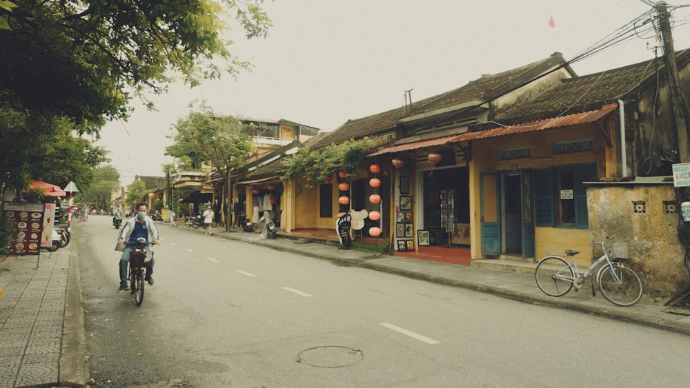 a person riding a bike down a street