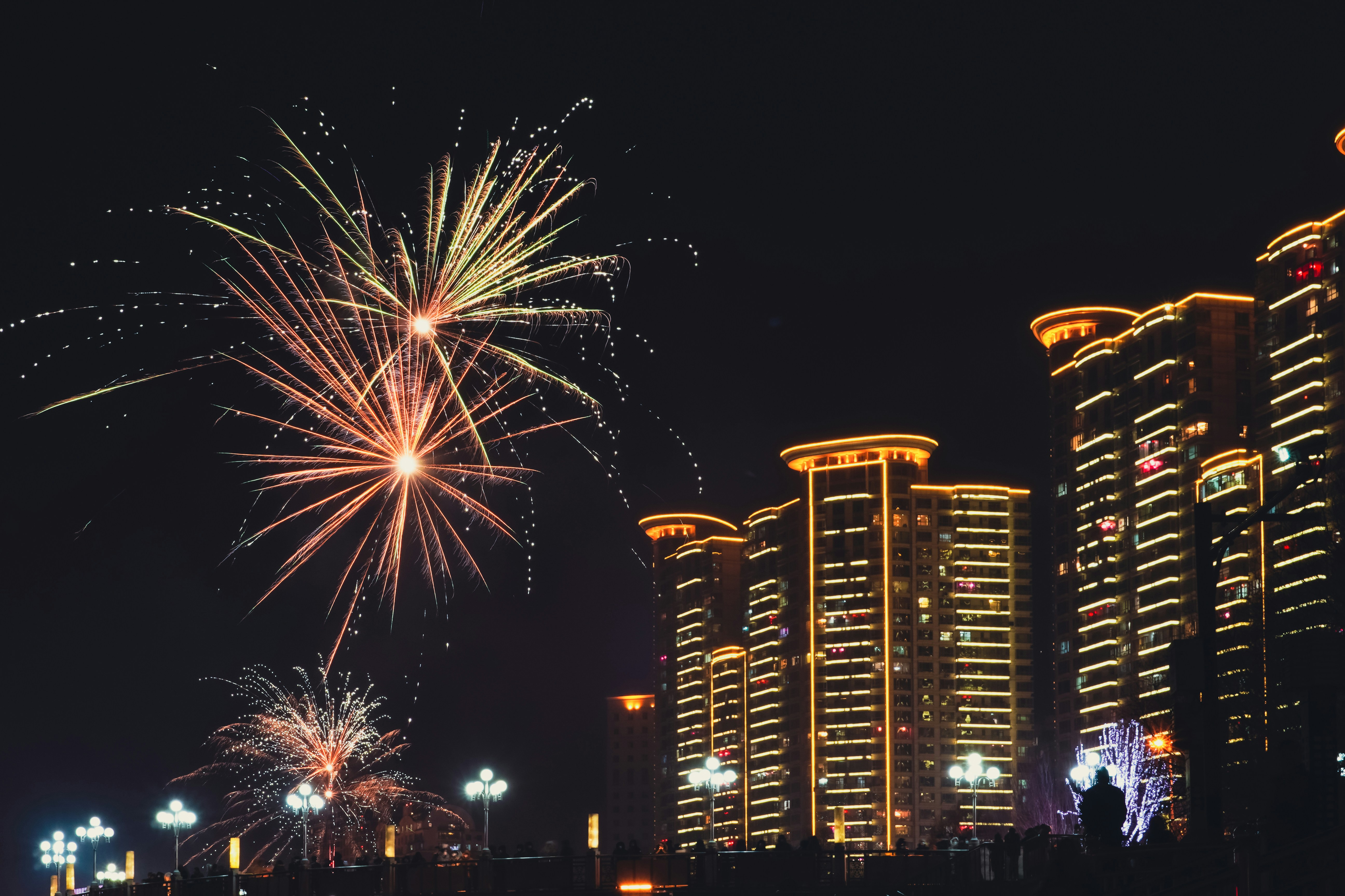 fireworks in the sky over a city at night