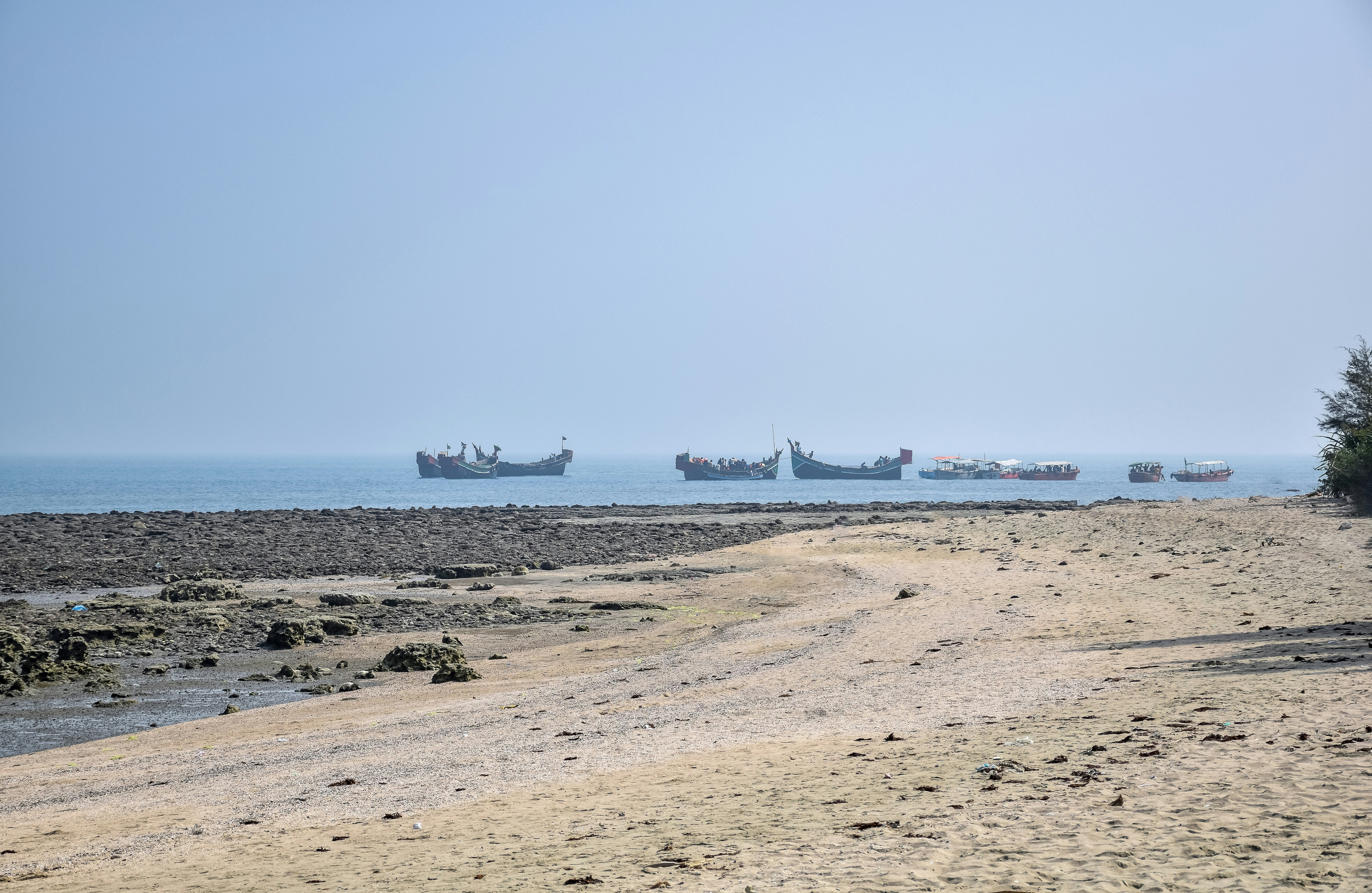 a group of boats floating on top of a body of water