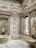 Elaborate interior space featuring intricately carved stone walls with floral and geometric patterns. The design includes arches, columns, and a large window that lets in natural light. The overall architecture displays a luxurious and ornate style.