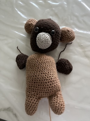 Close-up of a colorful amigurumi bear with intricate stitching.