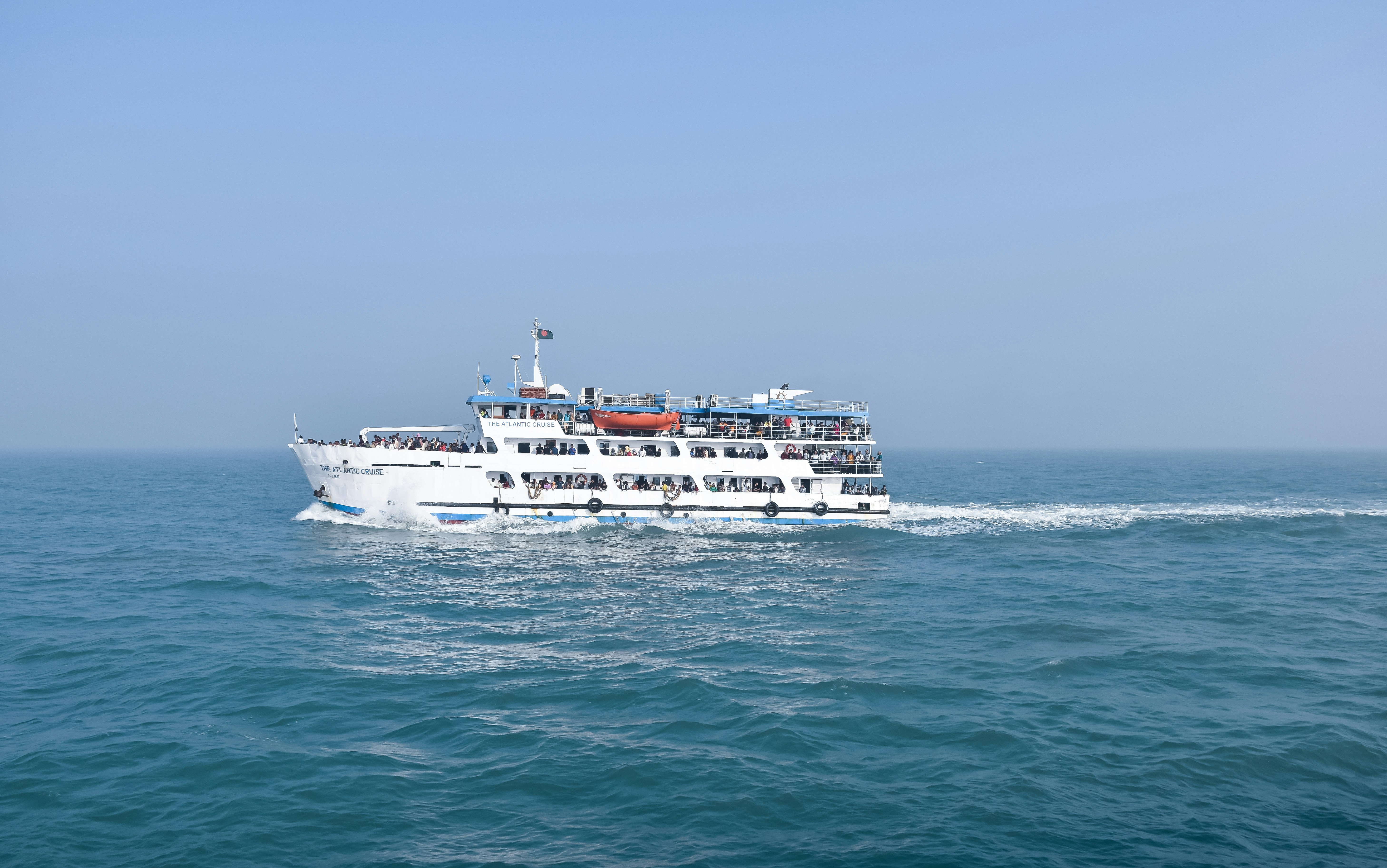 a large white boat traveling across a large body of water
