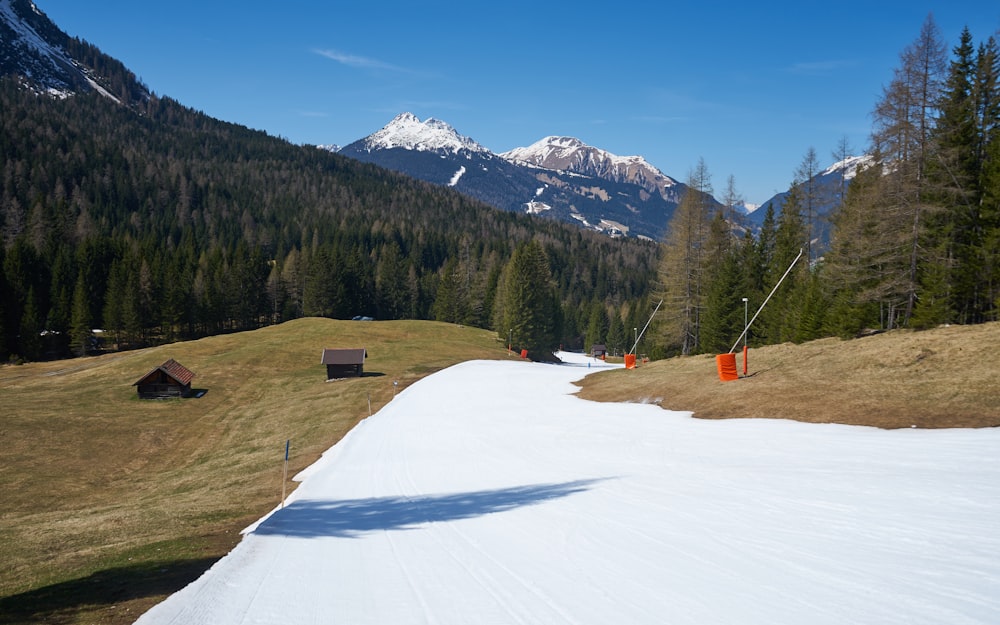 a snow covered field with a mountain in the background