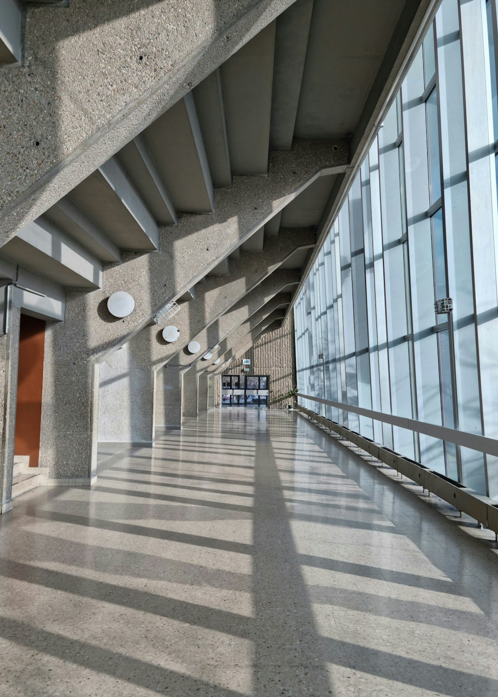 a long hallway with a concrete wall and ceiling