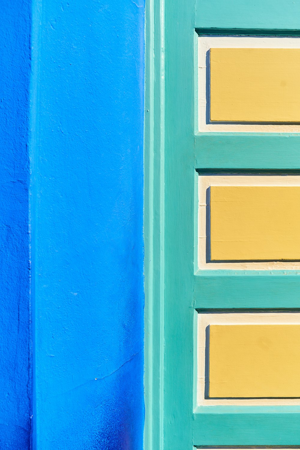 a close up of a blue and yellow door