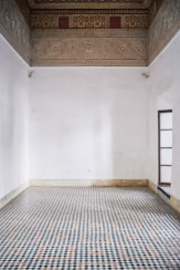 a room with a checkered floor and a window