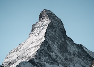 a snow covered mountain with a clear blue sky