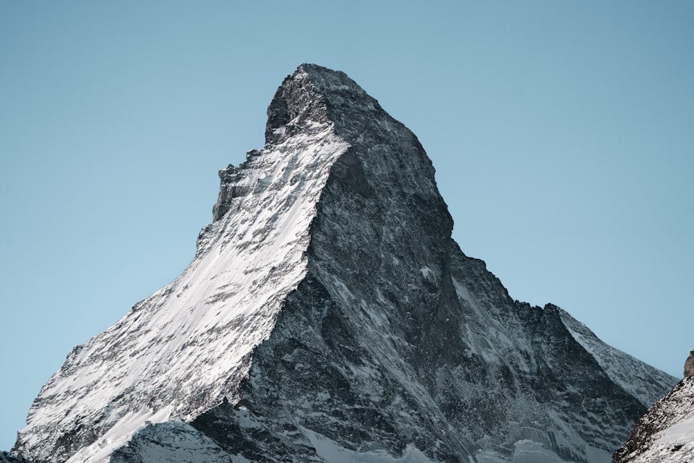 a snow covered mountain with a clear blue sky