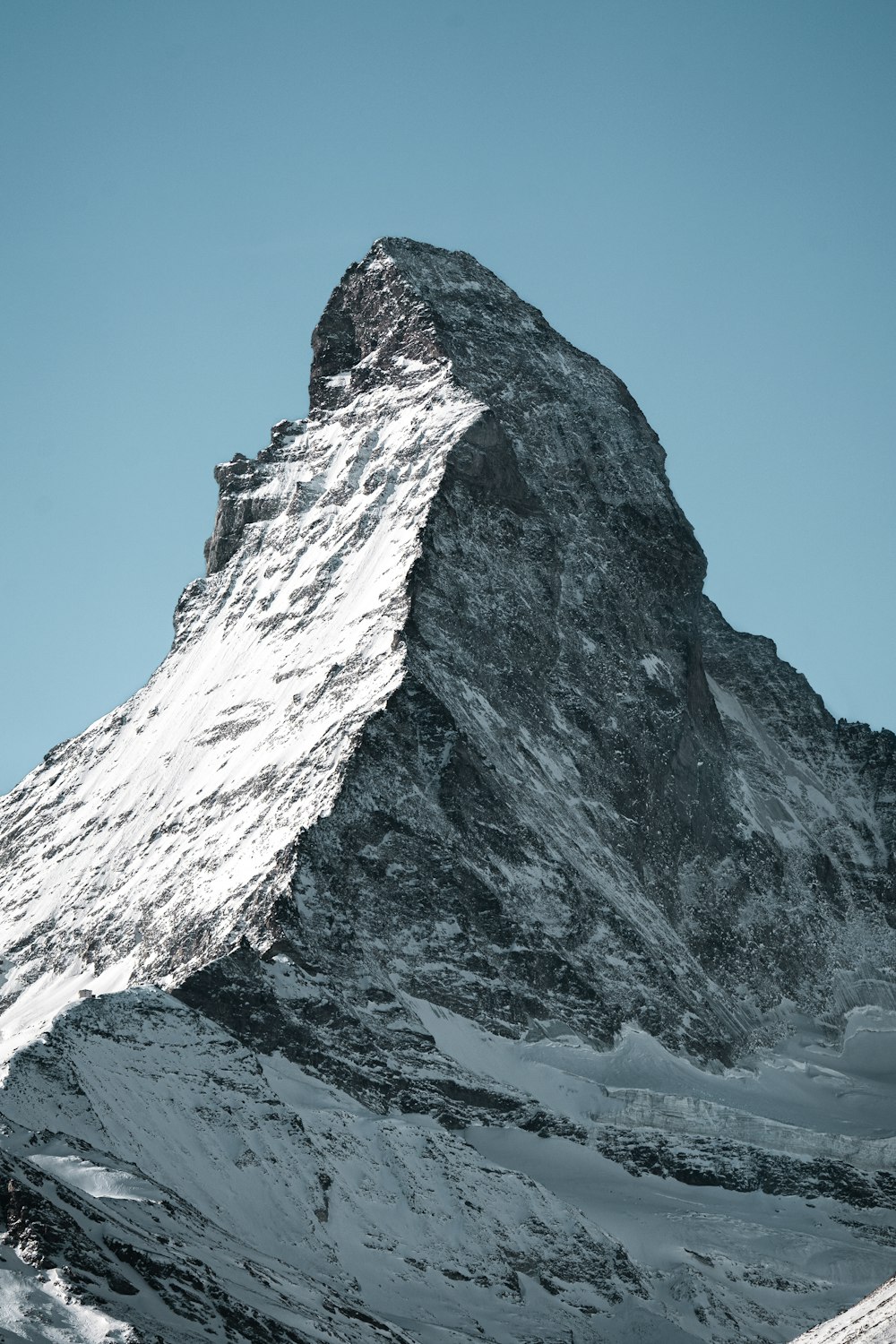 a snow covered mountain with a clear blue sky