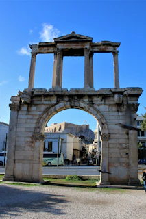 a stone arch with a clock on top of it