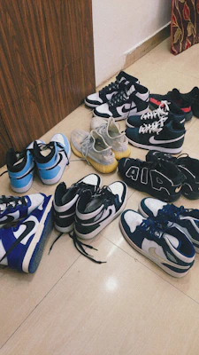 A collection of trendy sneakers in various colors lined up on a modern store floor.