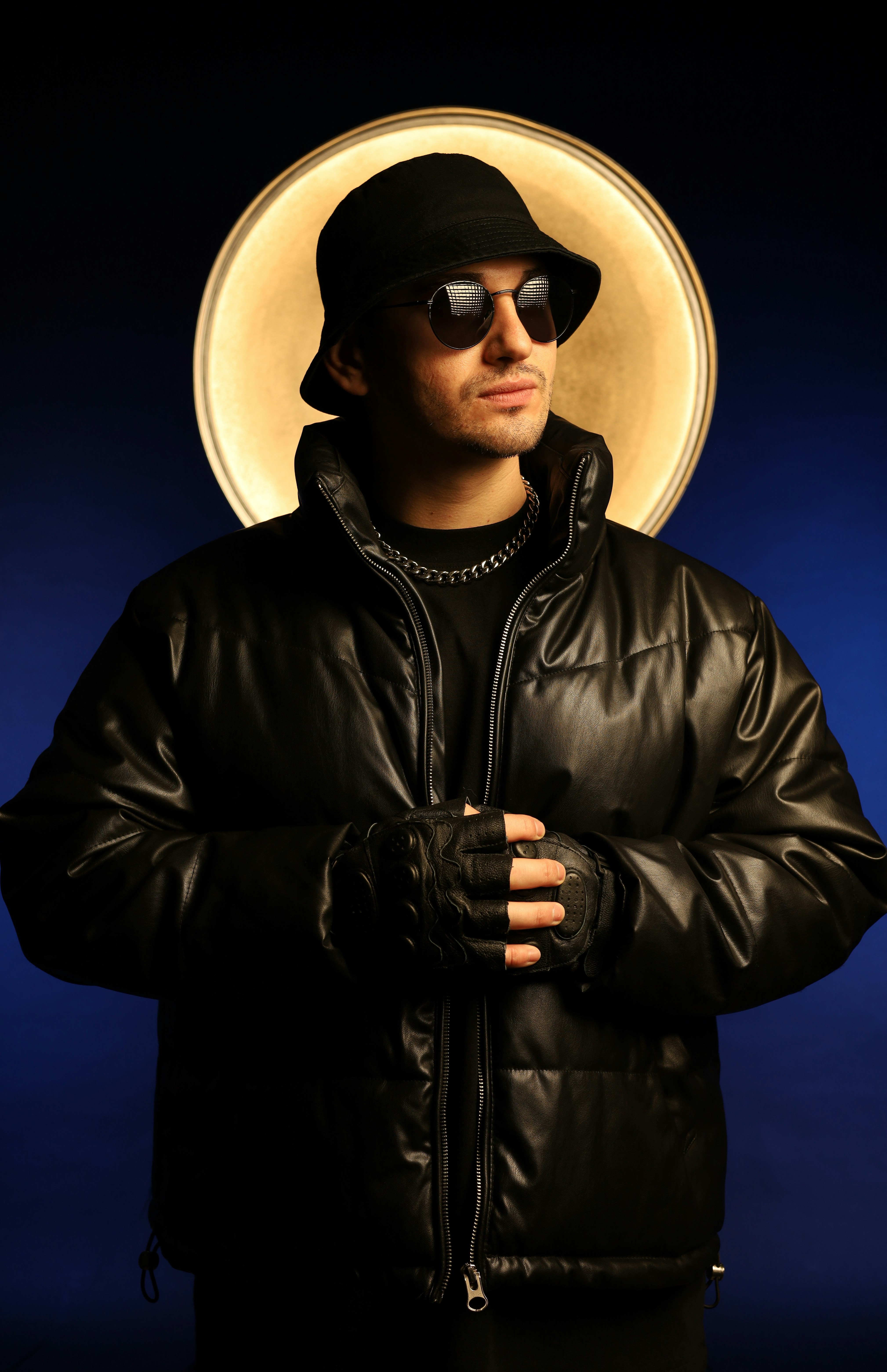 a man in a black jacket and hat